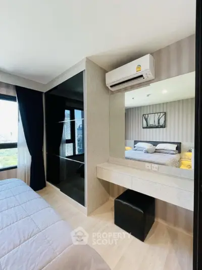 Modern bedroom with sleek design and city view, featuring built-in wardrobe and air conditioning.