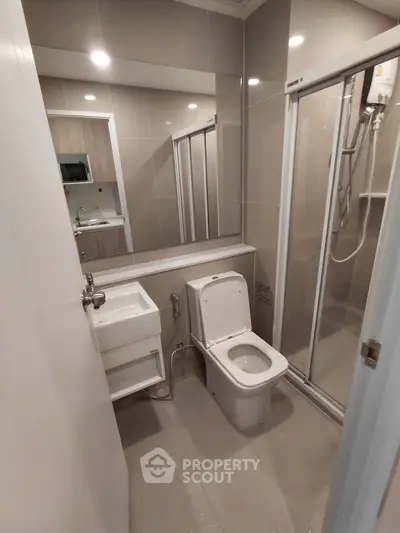 Modern bathroom with sleek shower and contemporary fixtures in a stylish apartment.