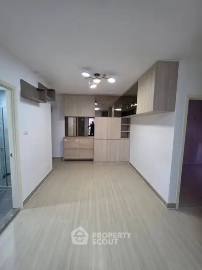 Spacious living room with modern cabinetry and sleek flooring