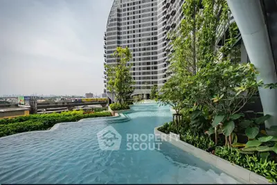 Luxurious high-rise building with stunning rooftop pool and lush greenery, offering breathtaking city views.