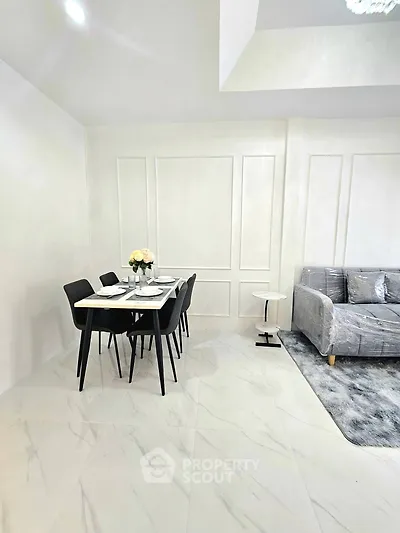 Modern living room with elegant dining area and sleek furniture