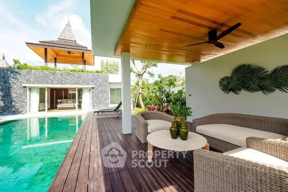 Luxurious villa with private pool and stylish outdoor seating area, perfect for relaxation and entertainment.