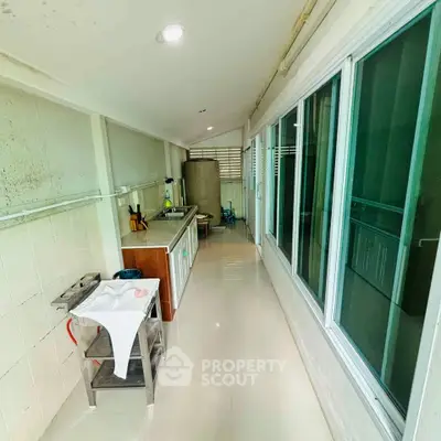 Spacious kitchen with sleek countertops and ample natural light, perfect for culinary enthusiasts.
