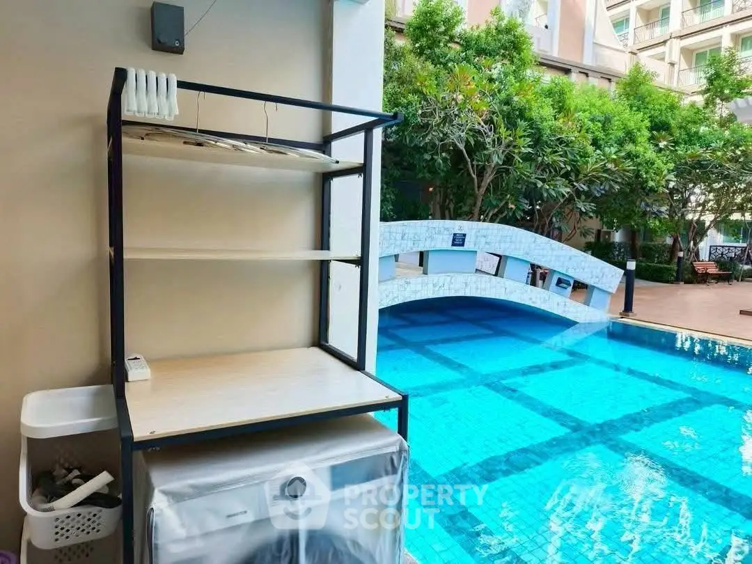 Luxurious poolside area with modern amenities and lush greenery, perfect for relaxation and leisure.