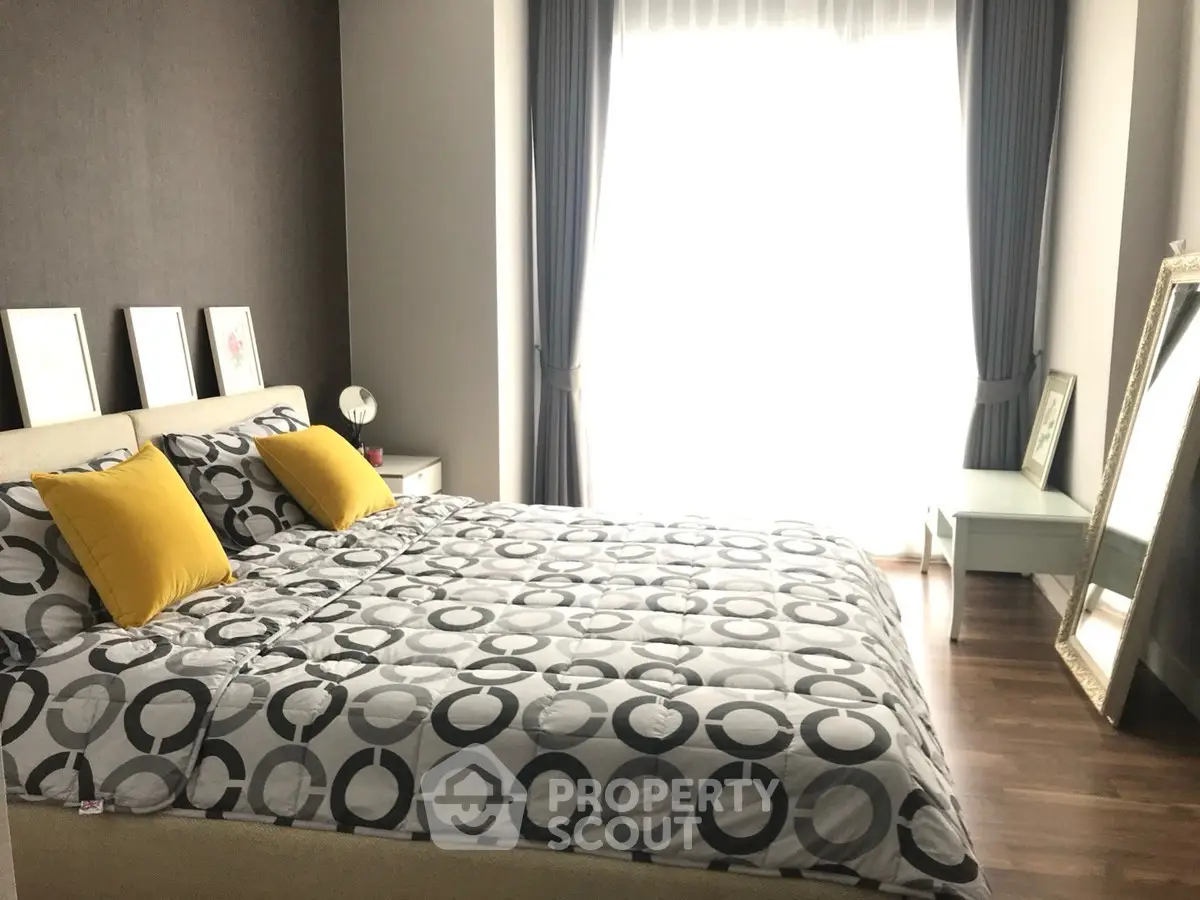 Bright and modern bedroom with stylish decor and large window for natural light.