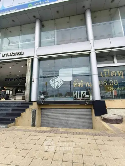 Modern commercial building exterior with large glass windows and sleek design.