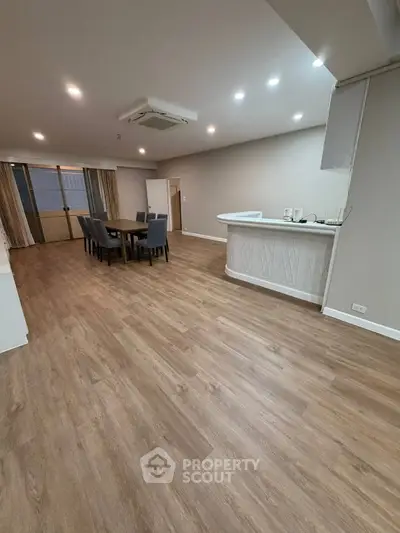 Spacious modern living room with elegant dining area and stylish flooring