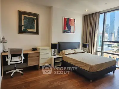 Modern bedroom with city view, stylish decor, and natural light.