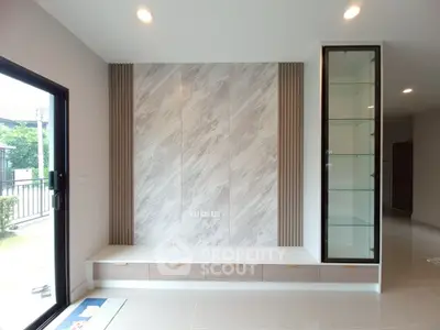 Modern living room with sleek built-in storage and large window view