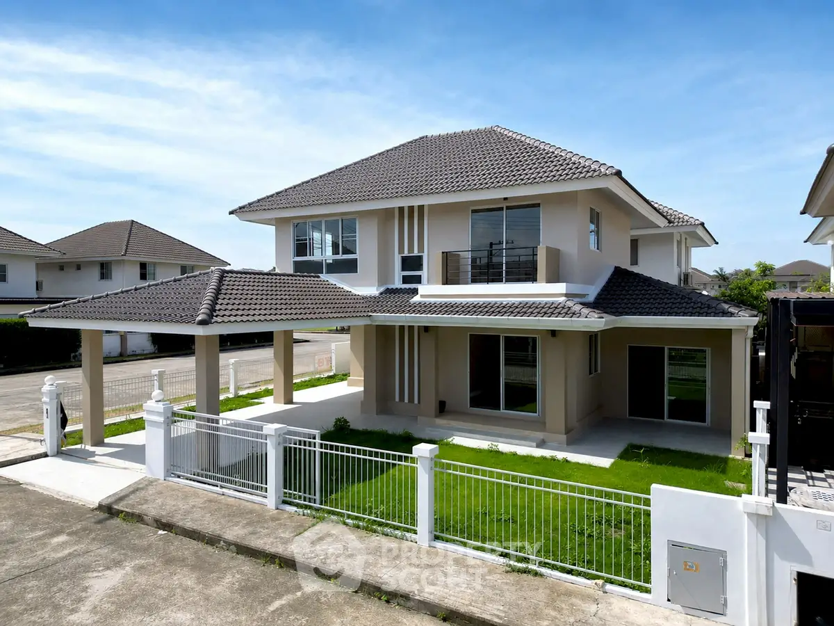 Stunning modern two-story house with spacious driveway and lush green lawn in a serene neighborhood.
