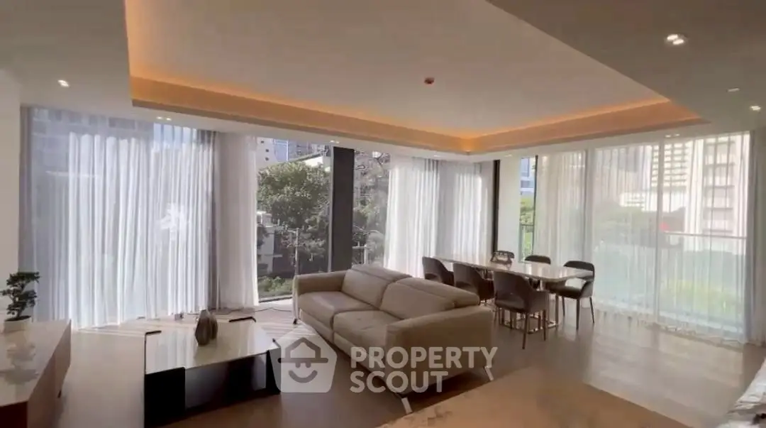 Spacious modern living room with large windows and elegant dining area in a luxury apartment.
