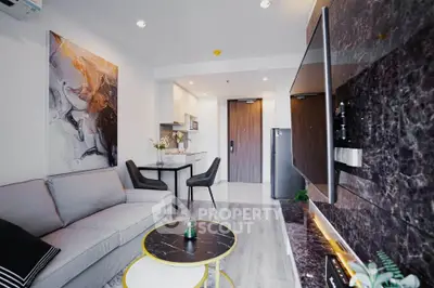 Modern living room with stylish decor and open kitchen layout in a contemporary apartment.