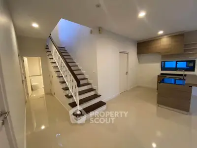 Modern interior with staircase and open kitchen layout in a stylish home