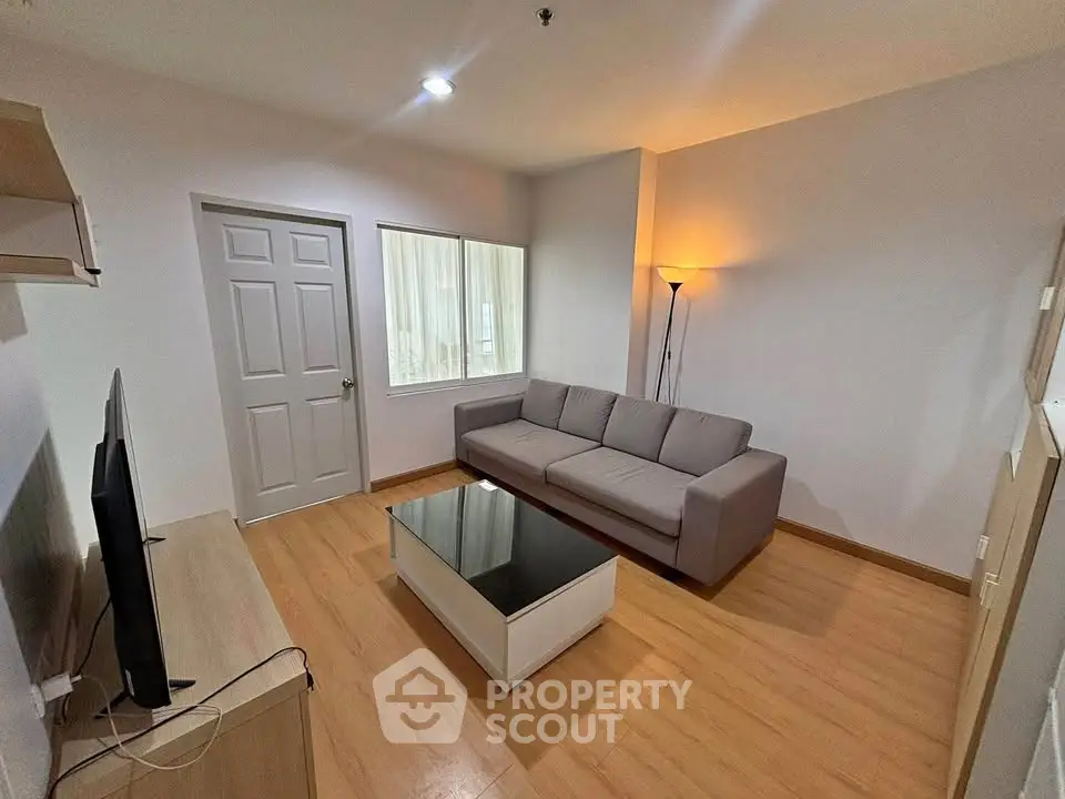 Cozy living room with modern sofa and sleek coffee table in a stylish apartment.