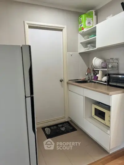 Compact kitchen with modern appliances and efficient storage solutions.