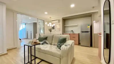 Modern living room with cozy sofa and open kitchen layout