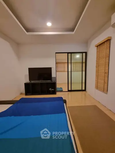 Spacious bedroom with modern decor and sliding glass doors