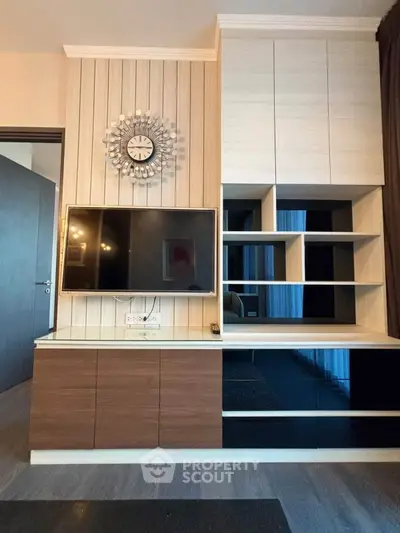 Modern living room with stylish TV unit and decorative wall clock