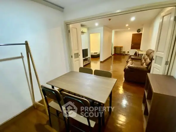 Spacious living room with wooden flooring and cozy seating area