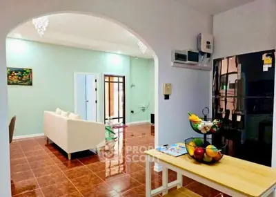 Charming open-plan living area with modern kitchen and cozy seating, perfect for entertaining.