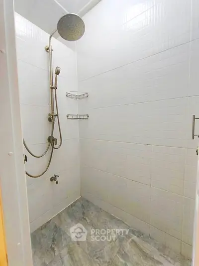 Modern bathroom with sleek shower fixtures and tiled walls