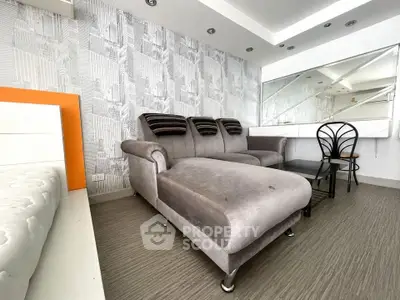 Modern living room with stylish gray sofa and chic decor