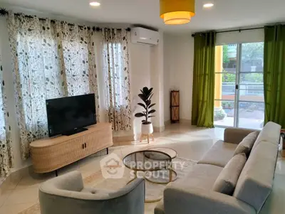 Spacious living room with modern decor and large windows for natural light.