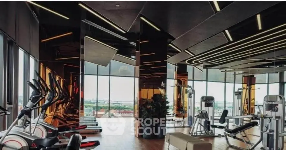 Luxurious high-rise gym with panoramic city views and modern fitness equipment.
