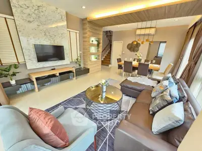 Luxurious modern living room with elegant decor and open dining area, featuring stylish furniture and ambient lighting.