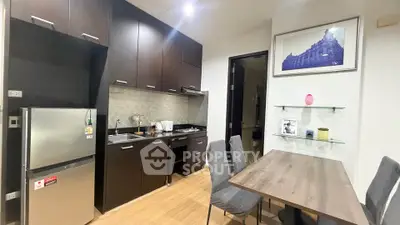 Modern kitchen with dark cabinets and dining area in stylish apartment