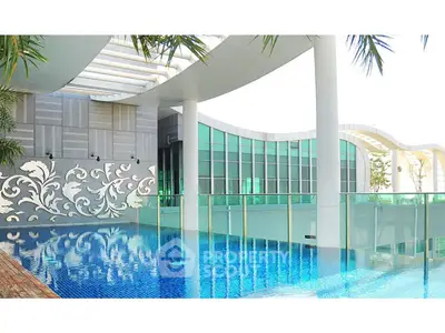 Luxurious rooftop pool with modern architectural design and glass railings