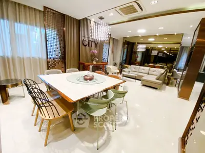 Luxurious open-plan living and dining area with modern decor and elegant lighting.