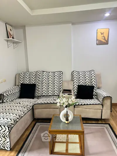 Stylish living room with patterned sofa and elegant decor