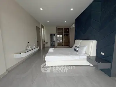 Spacious modern bedroom with sleek design and elegant furnishings
