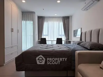 Modern bedroom with stylish decor, large window, and cozy atmosphere in a contemporary apartment.