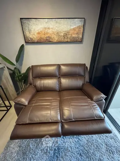 Luxurious leather recliner in modern living room with stylish decor and plush rug