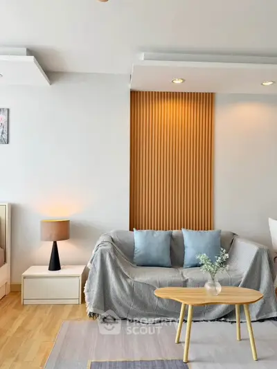 Modern living room with stylish decor and cozy seating area, perfect for relaxation.