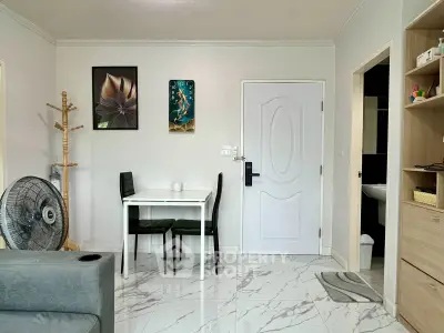 Modern living room with sleek decor and marble flooring, featuring a cozy dining area and stylish wall art.