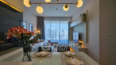 Modern living room with elegant decor and city view, featuring stylish lighting and cozy seating area.