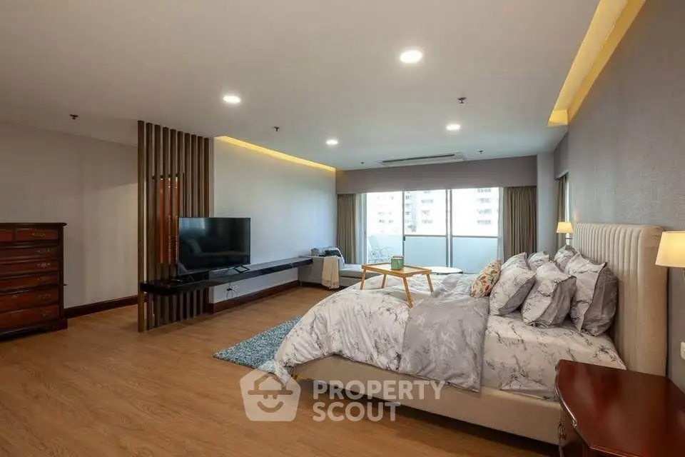 Spacious modern bedroom with elegant decor and natural light