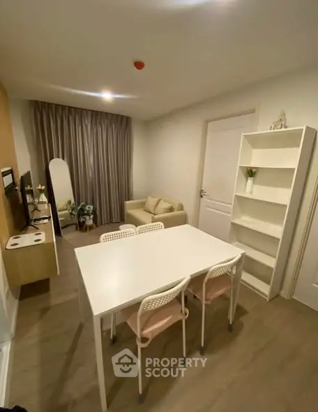 Modern living room with cozy sofa and dining area in stylish apartment.