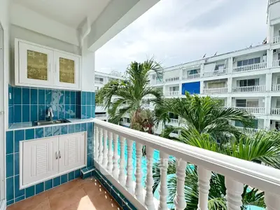 Charming balcony with pool view in tropical resort setting