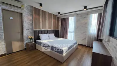 Modern bedroom with stylish wood paneling and large windows in a contemporary apartment.