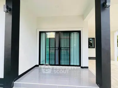 Modern patio with sliding glass doors and sleek black columns