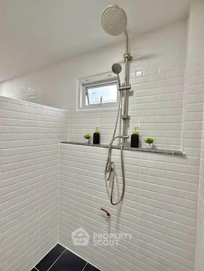 Modern bathroom with sleek shower and white subway tiles, perfect for a refreshing experience.