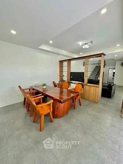 Spacious modern living room with elegant wooden dining set and open layout