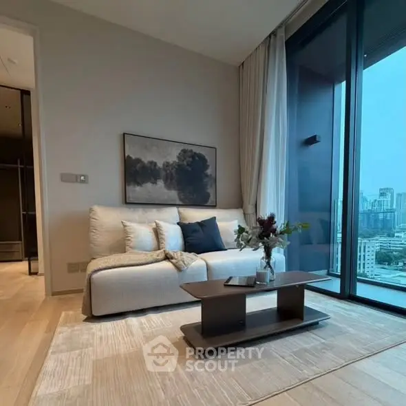 Modern living room with city view, elegant decor, and cozy seating area.