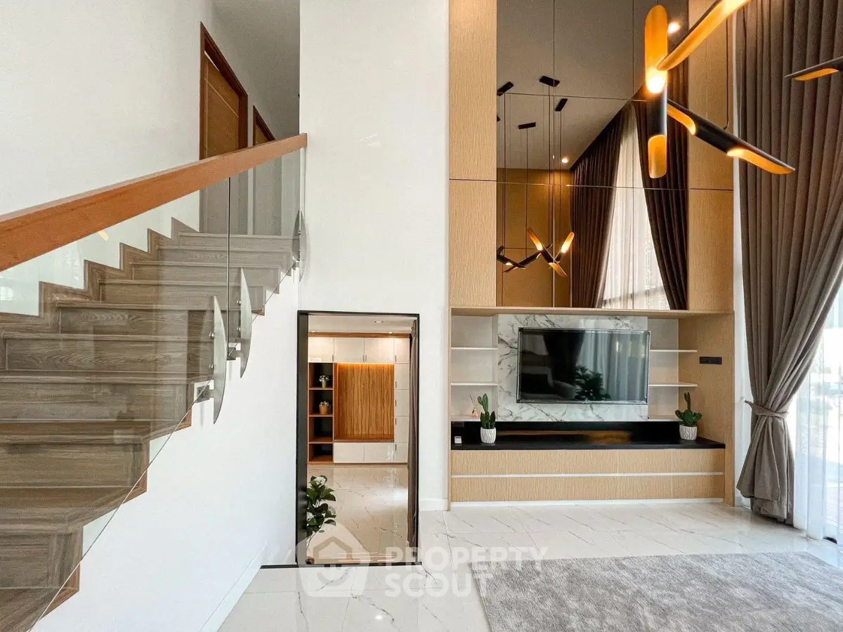Luxurious modern living room with high ceiling and elegant staircase