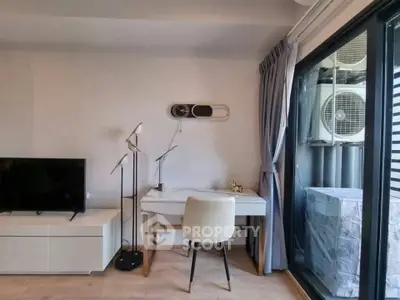 Modern living room with sleek furniture and large window for natural light