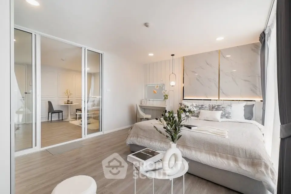 Luxurious modern bedroom with elegant decor and spacious layout, featuring a stylish vanity and cozy ambiance.